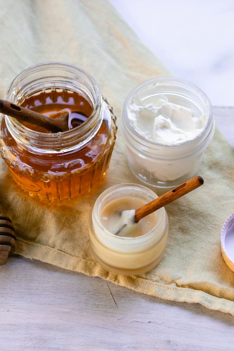 My DIY lip mask recipe finished in a glass bowl with a wooden spoon. 