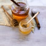 A homemade lip mask in a small jar with a spoon for stirring.