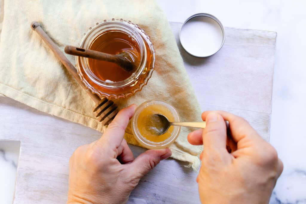 Using a small spoon to stir the ingredients.