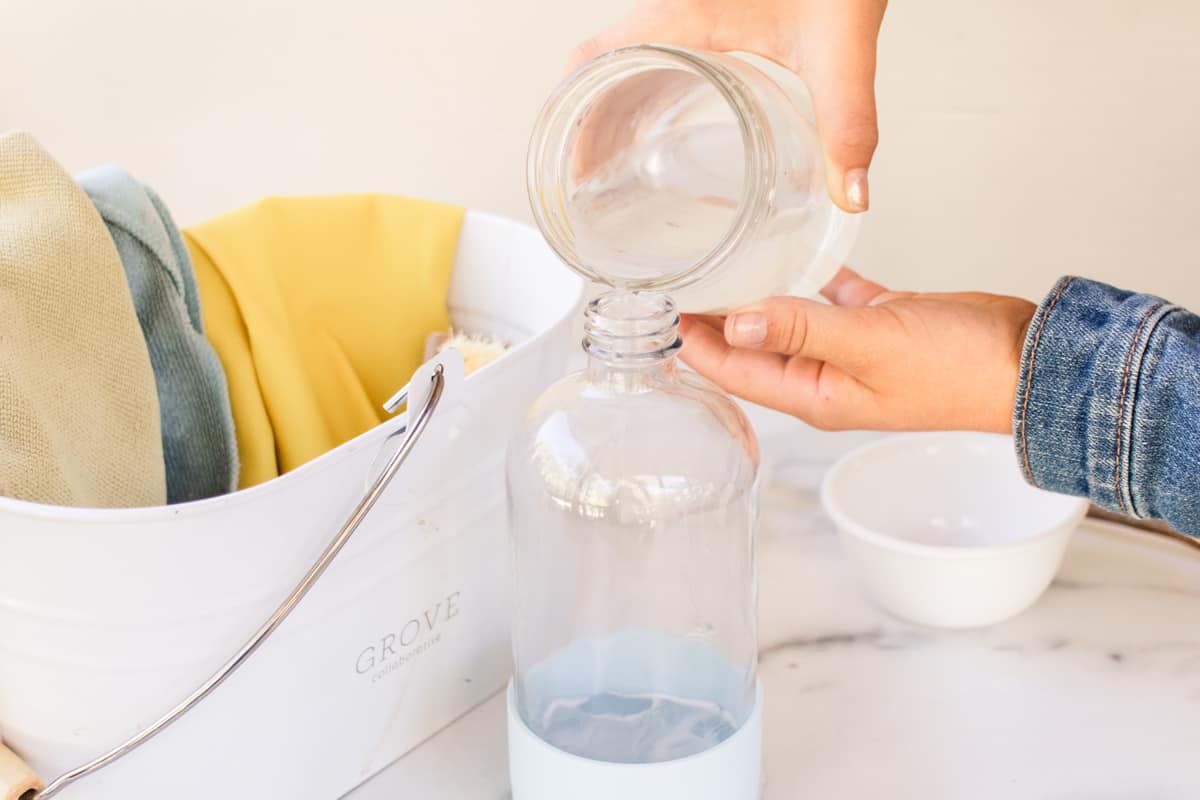 Pouring the liquid into a spray bottle.