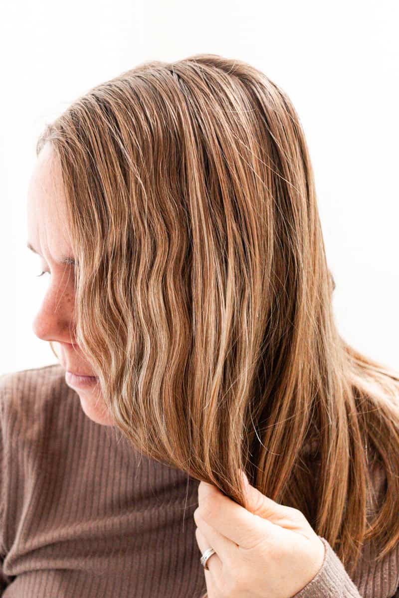 Scrunching up naturally curly hair.