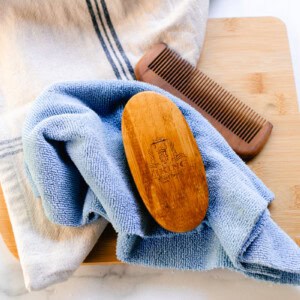 Drying the clean beard brush with the bristles facing down on a clean cloth.