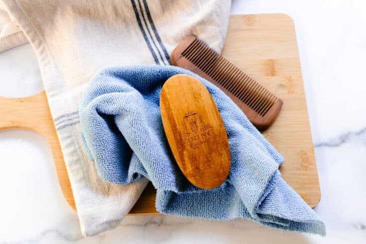 Drying the clean beard brush with the bristles facing down on a clean cloth.