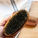 Cleaning a wooden beard brush.