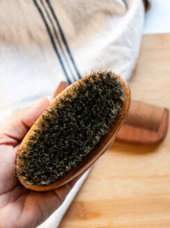 Cleaning a wooden beard brush.