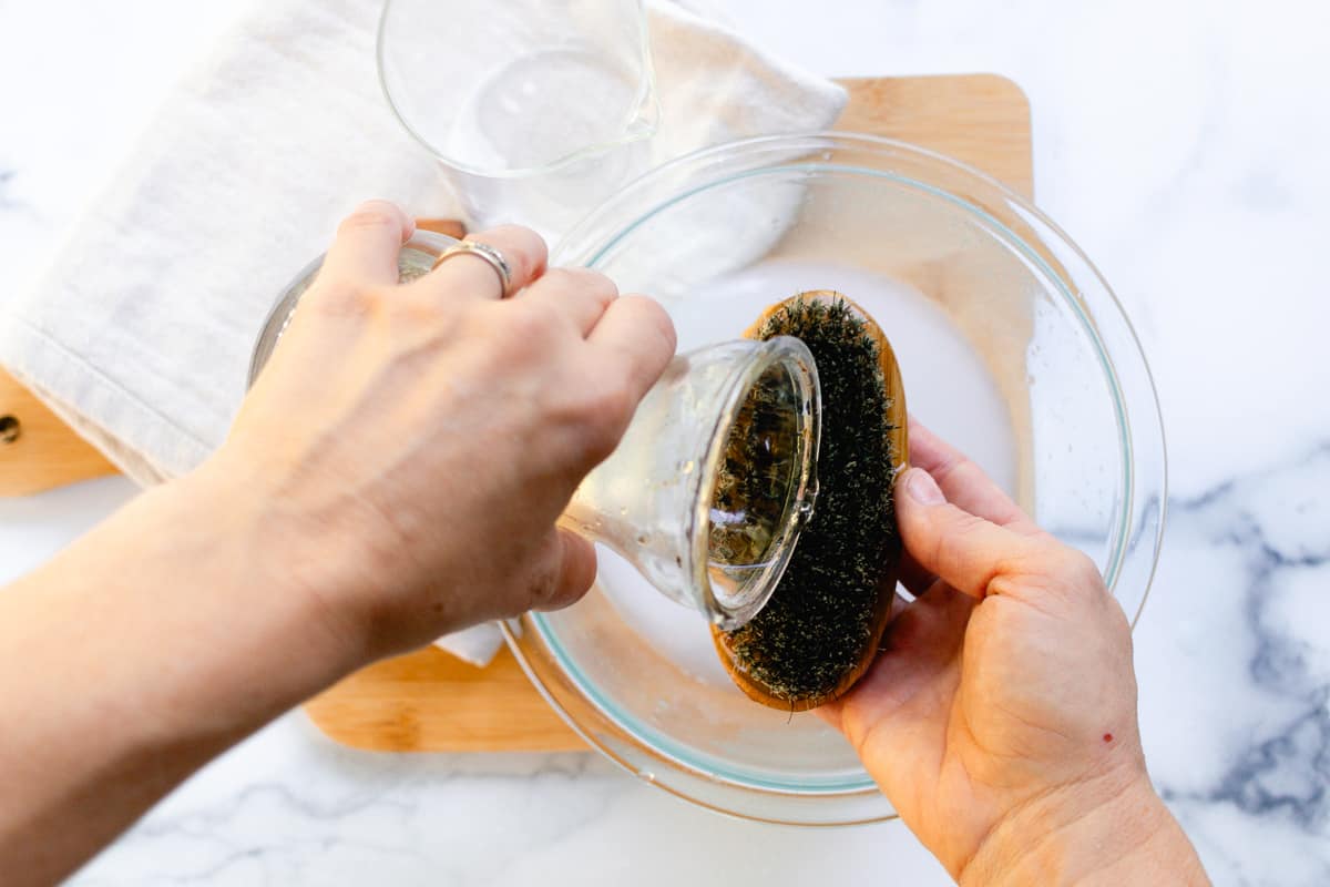 Rinsing with clean water over a bowl.