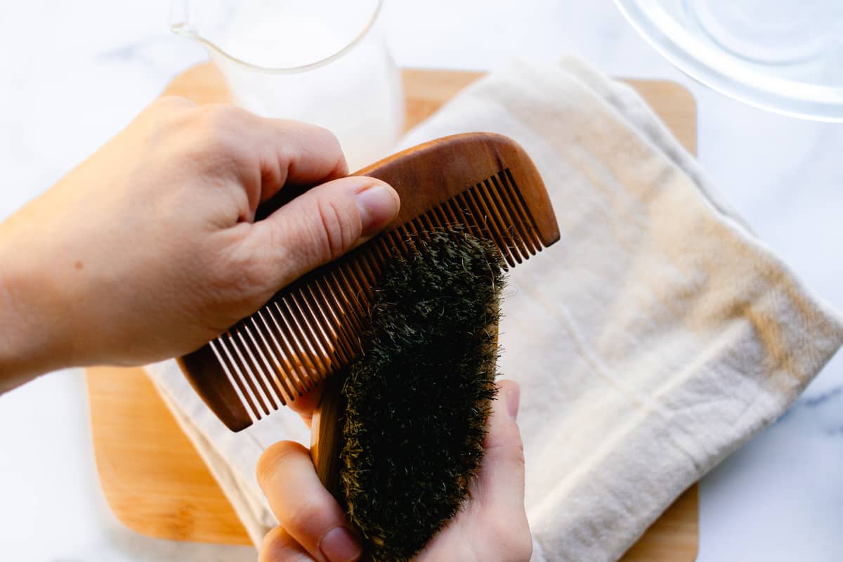 Brushing out the beard brush with a beard comb. 
