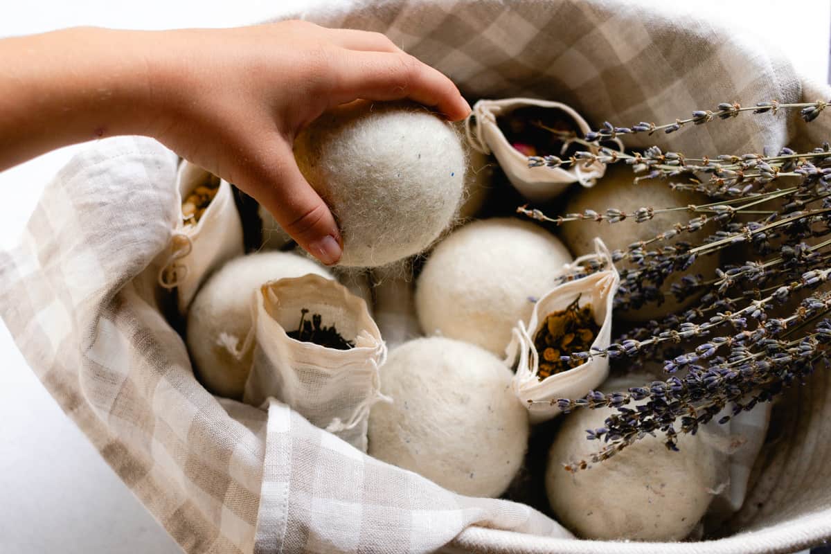 Grabbing a wool dryer ball out of the basket.