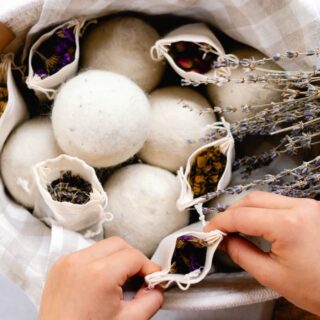 Scenting wool dryer balls with dried herbs in breathable muslin bags.