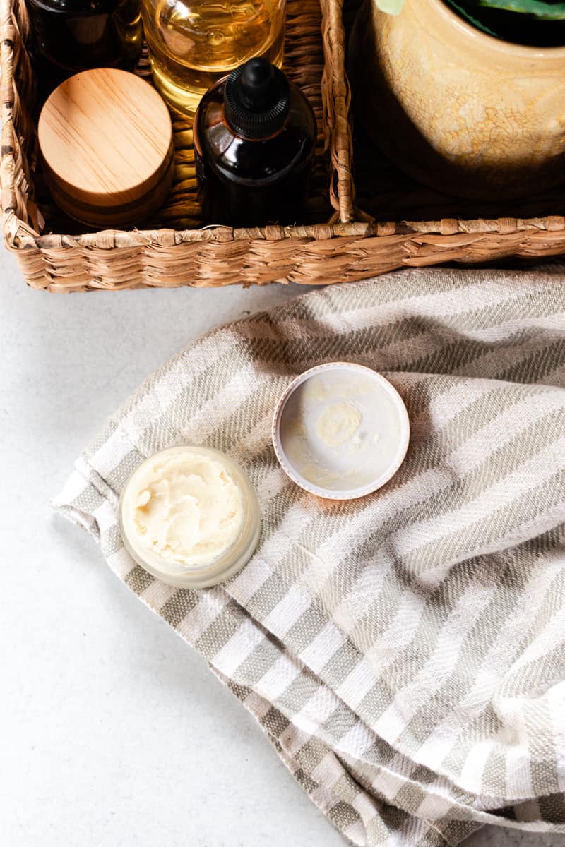 Several beard styling products, all homemade, in a basket.