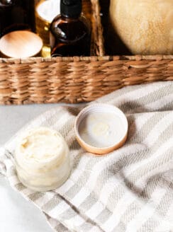 A beard balm on a white and grey tea towel.