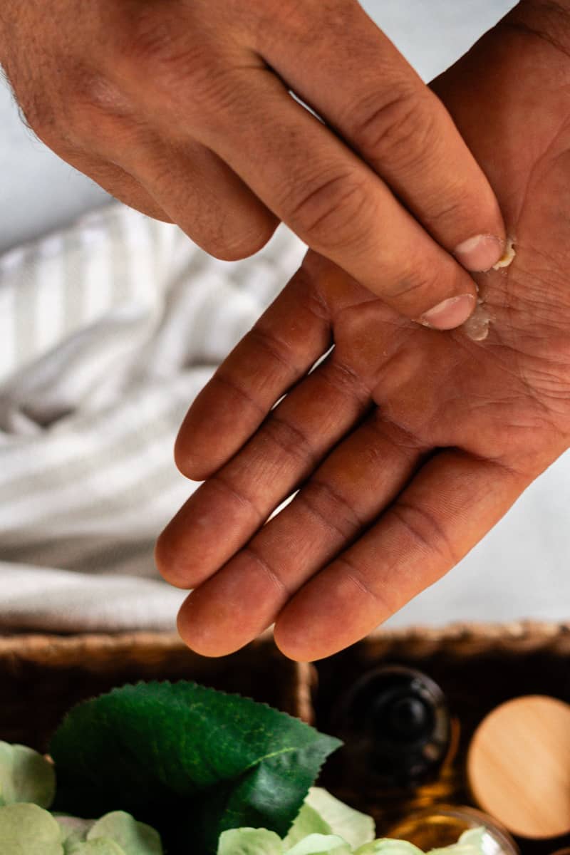 Smearing a touch of a beard balm onto my hands to melt before applying to the beard.