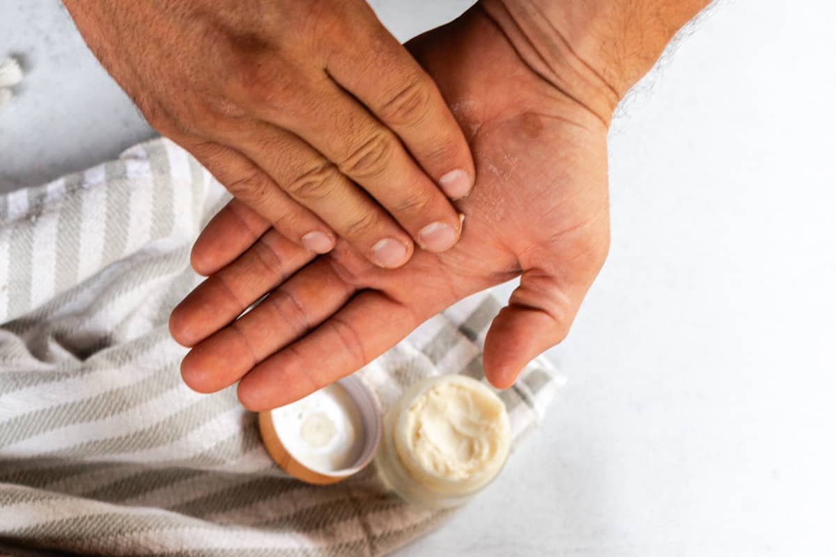 Melting a beard balm between the hands.