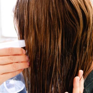Spraying coconut water into the hair.
