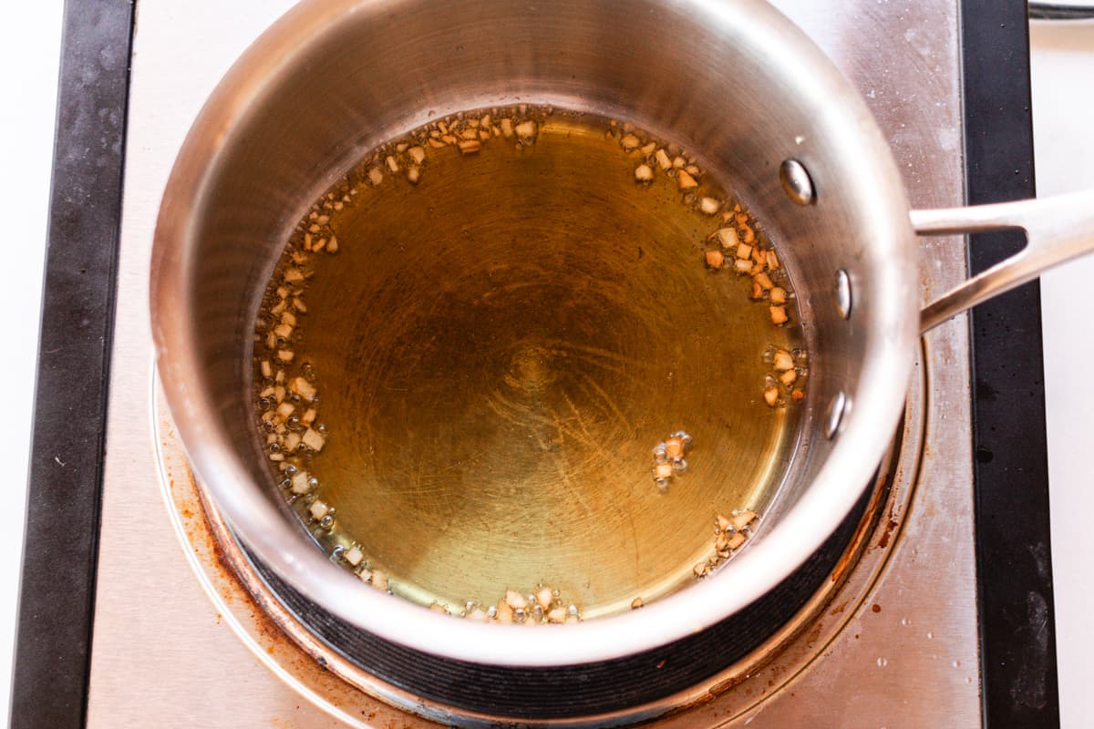 Heating the olive oil with the garlic on the stove.