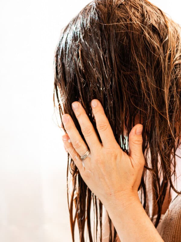 Applying epsom salt shampoo to the hair.