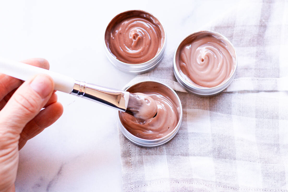 Dipping a foundation brush into the liquid foundation that I made using lotion.