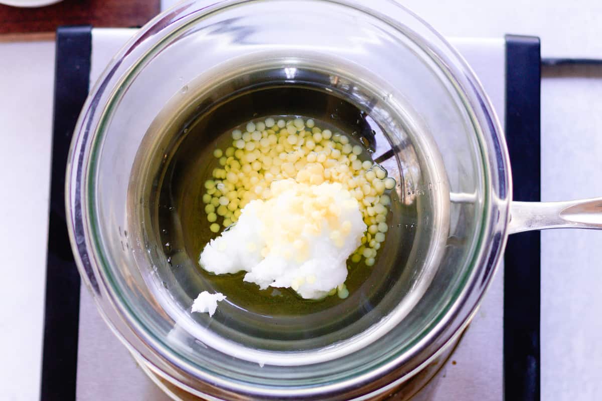 Using a double boiler to melt the ingredients.