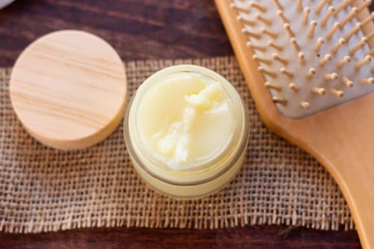 Homemade oil based hair pomade in a small glass jar.