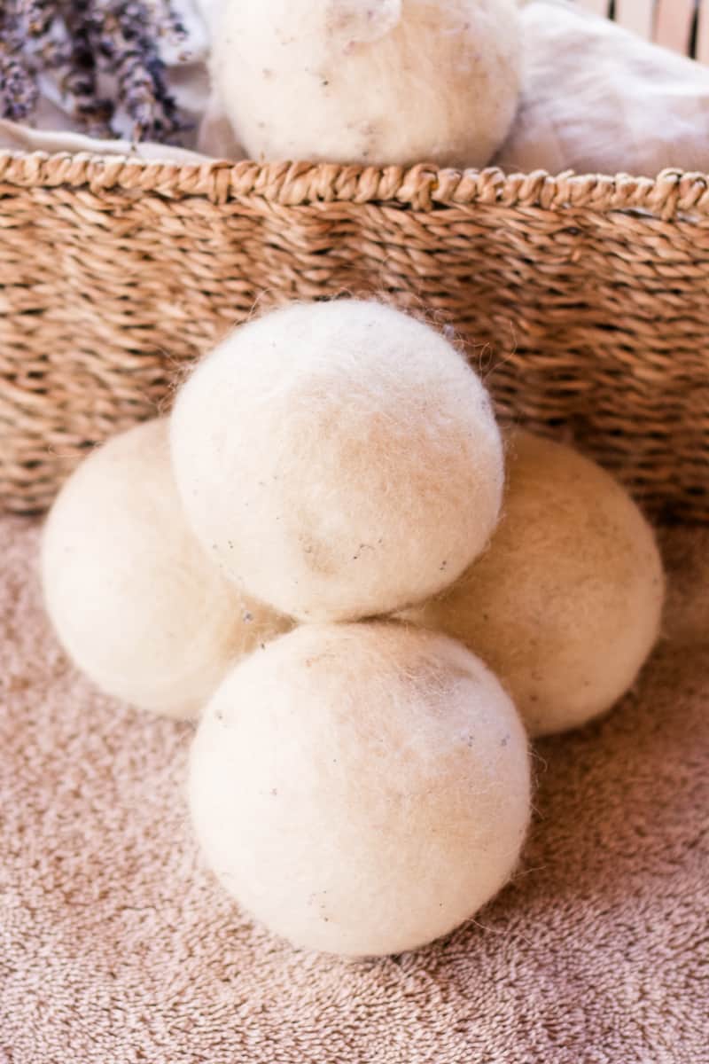 Storing the dryer balls in a whisker basket and several others stacked next to it.