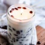 A beautiful coffee scented candle with coffee beans pressed against the sides.