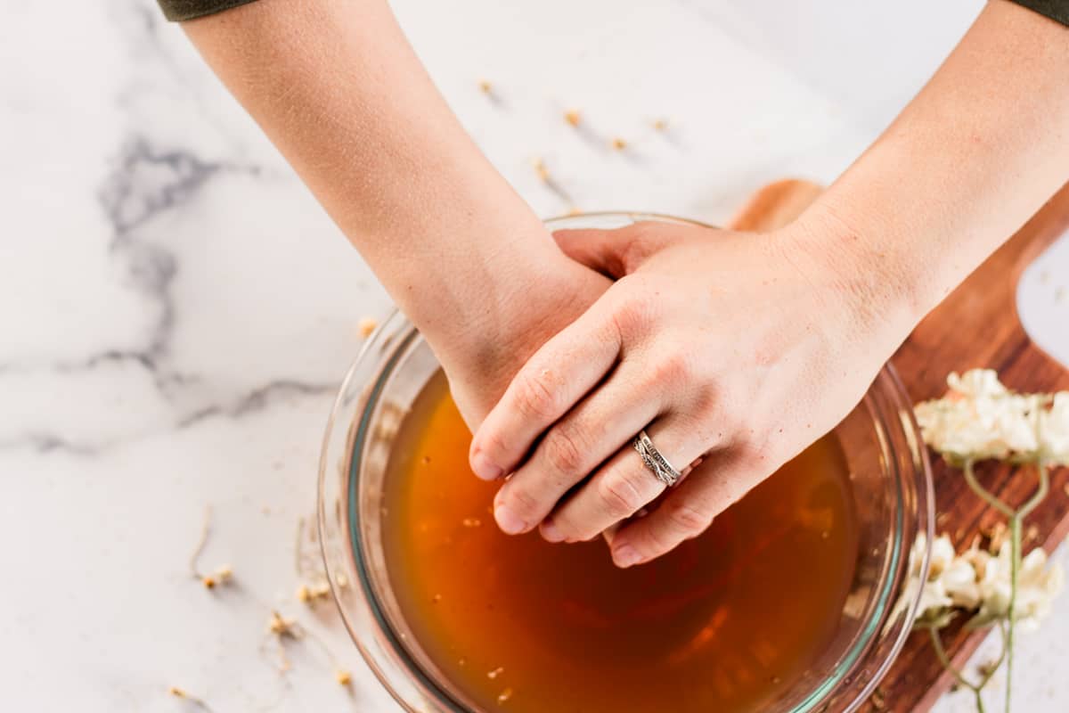 Putting hands into the soak.