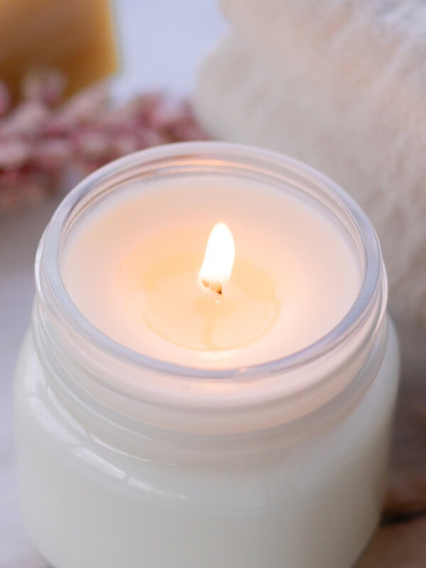 A DIY soy wax candle burning.
