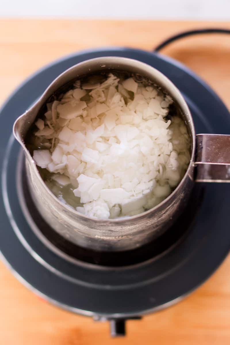 Melting soy wax flakes in a wax melter.