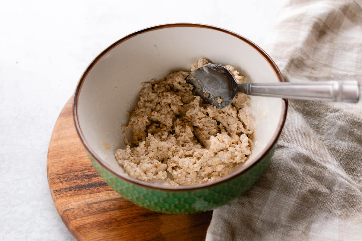 Oatmeal and yogurt face mask all mixed together in a green bowl.