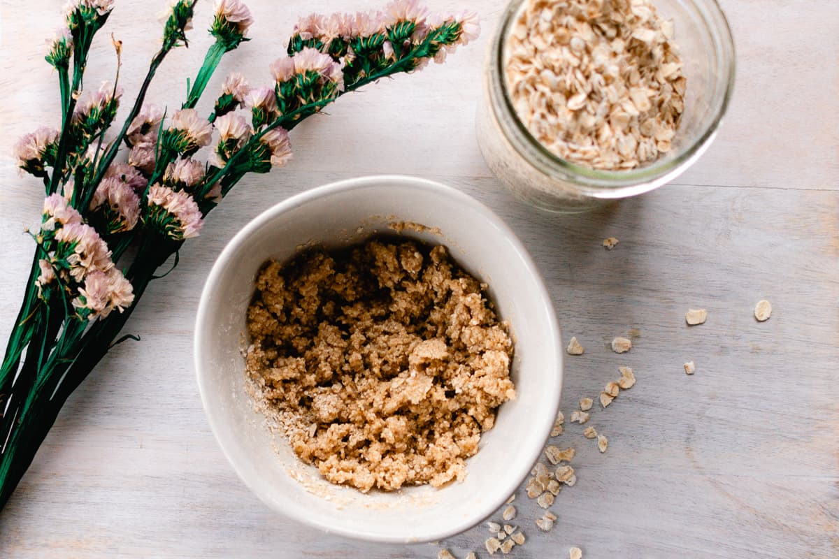 A homemade oatmeal face mask in a small bowl ready to apply to the skin.