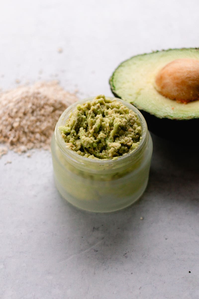 Oatmeal and avocado face mask all mixed together in a glass container.