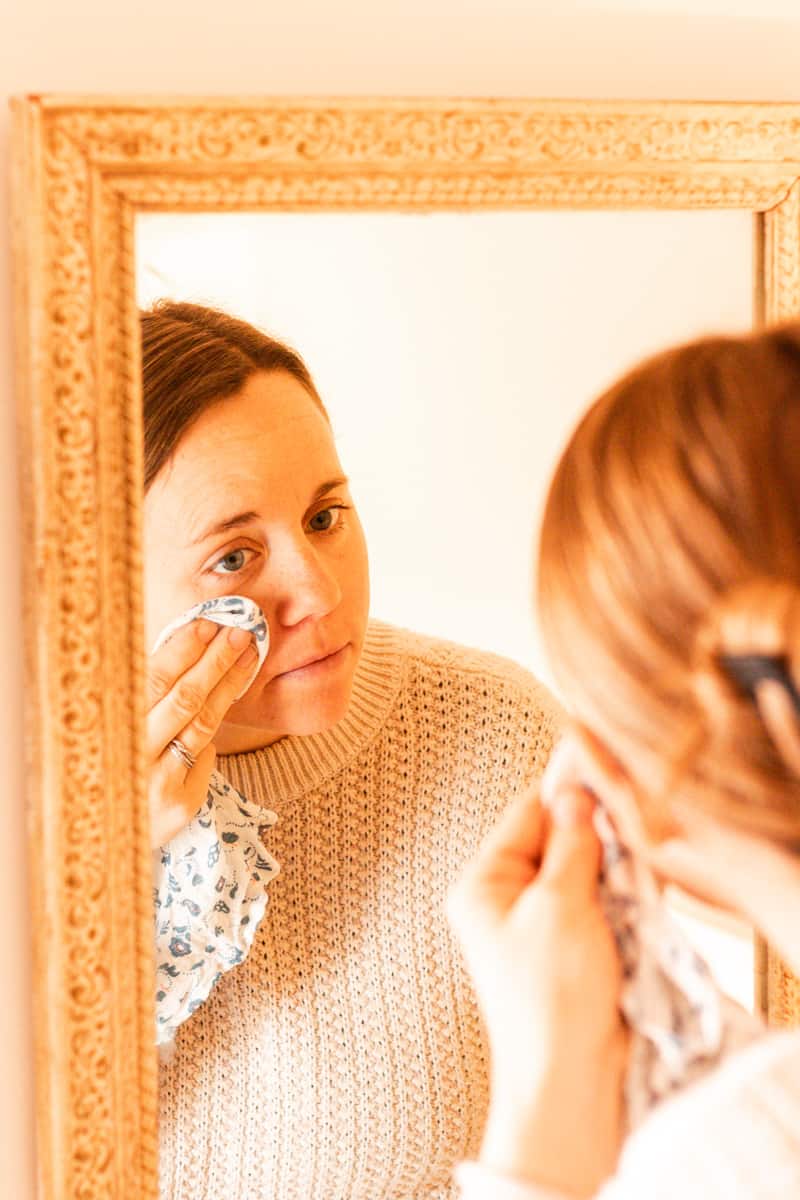 Wiping off the face mask with a damp towel.