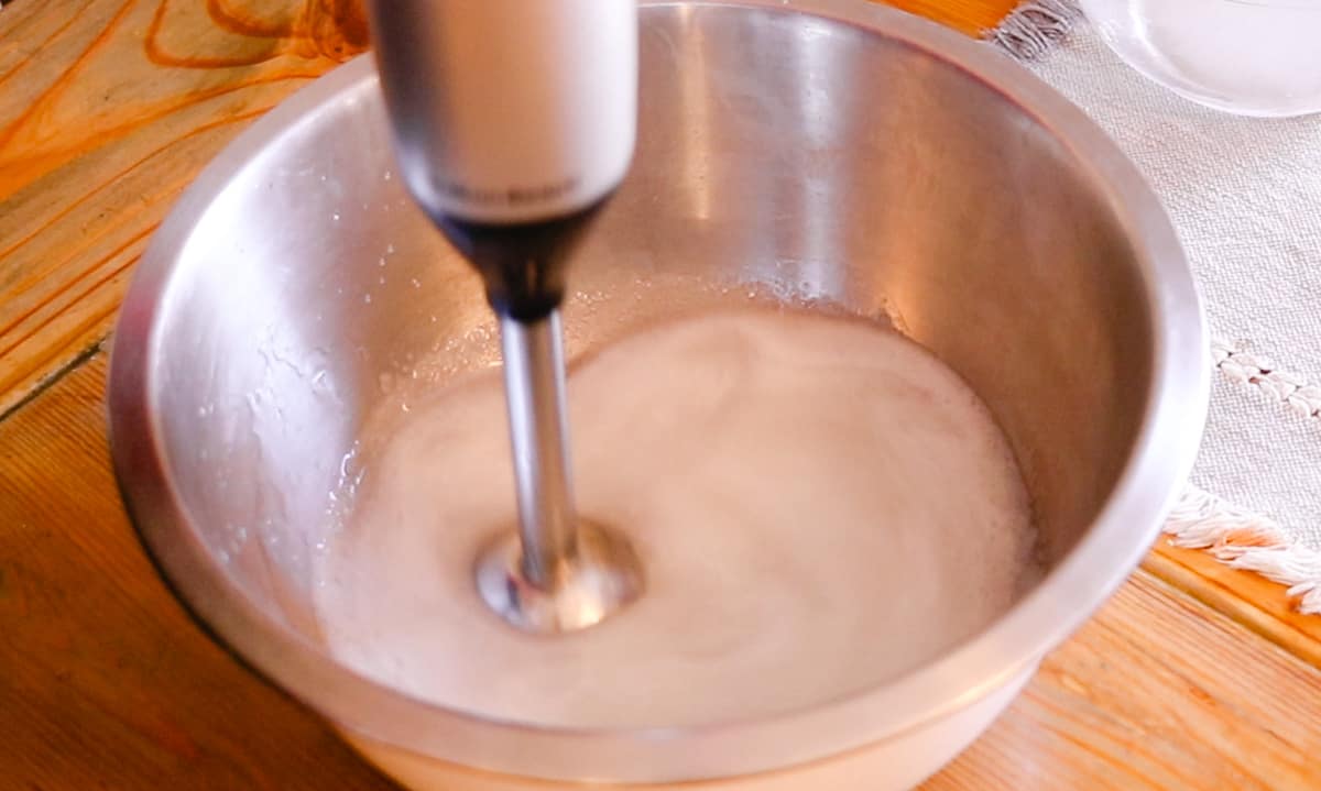Mixing the wet soap with an immersion blender to bring it to trace.