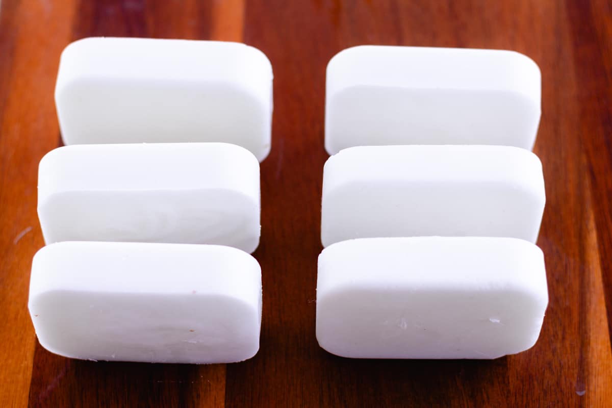 Laying out the bars of soap on a wooden table on their ends so that they can cure properly.