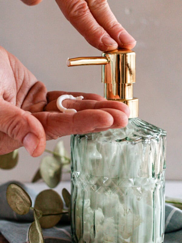 Pumping homemade lotion into my hand.