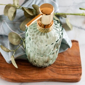 A homemade pumpable lotion on a white marble table.