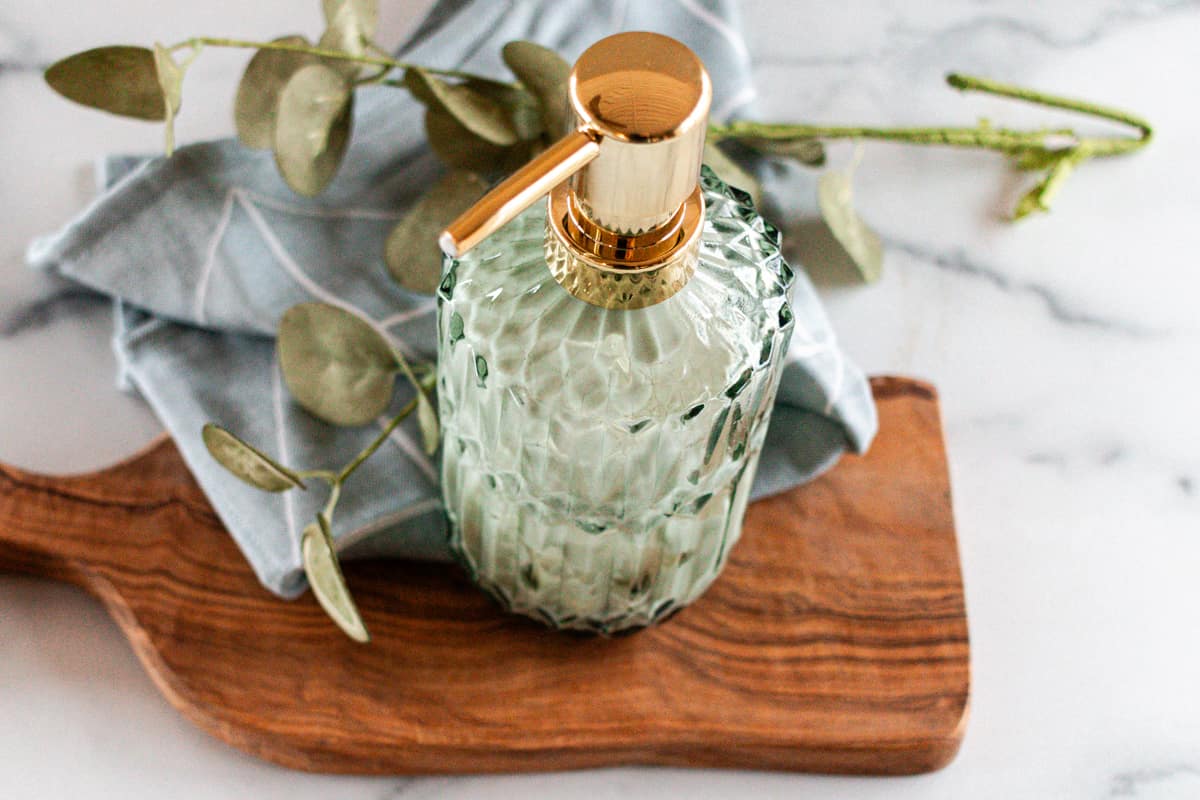 A homemade pumpable lotion on a white marble table.