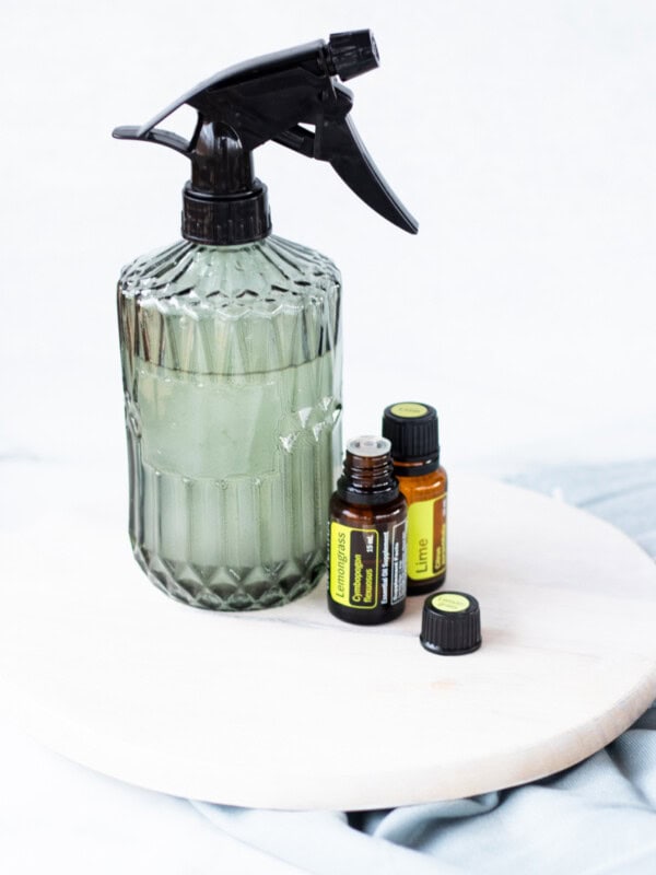 A homemade room spray with fragrance oils next to it.