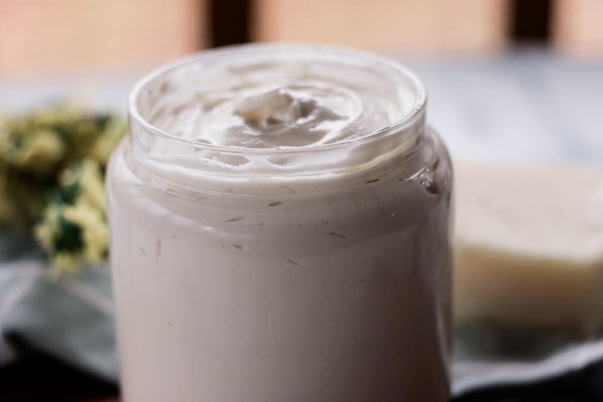 Homemade hair butter in a glass jar after it has been whipped.