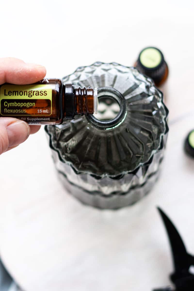 Adding the fragrance essential oils to the top of the spray bottle.