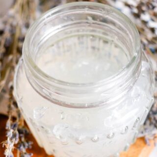 DIY hair gel made with gelatin in a glass jar with dried lavender sprigs.