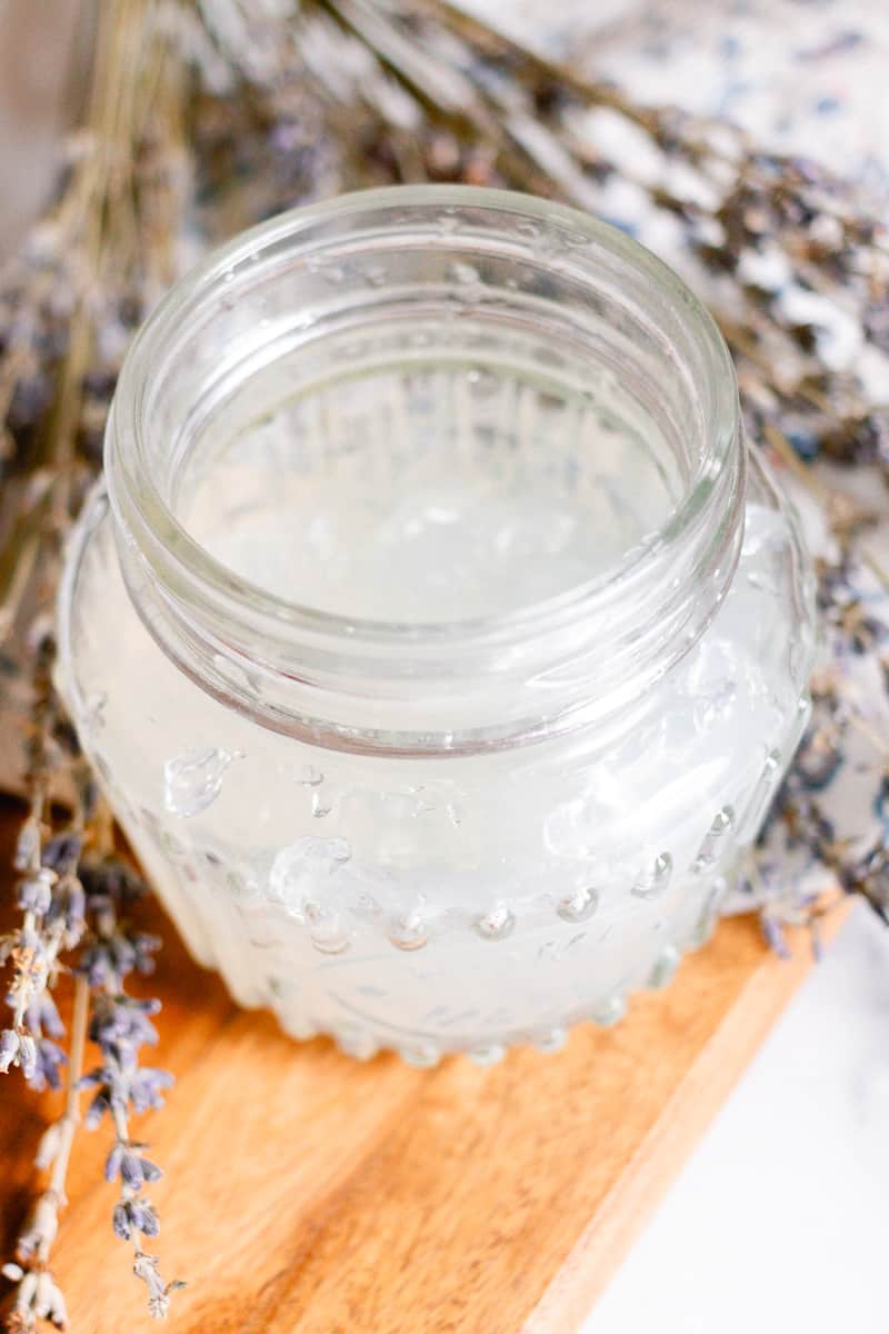 Homemade hair gel in a glass jar as it sets up.