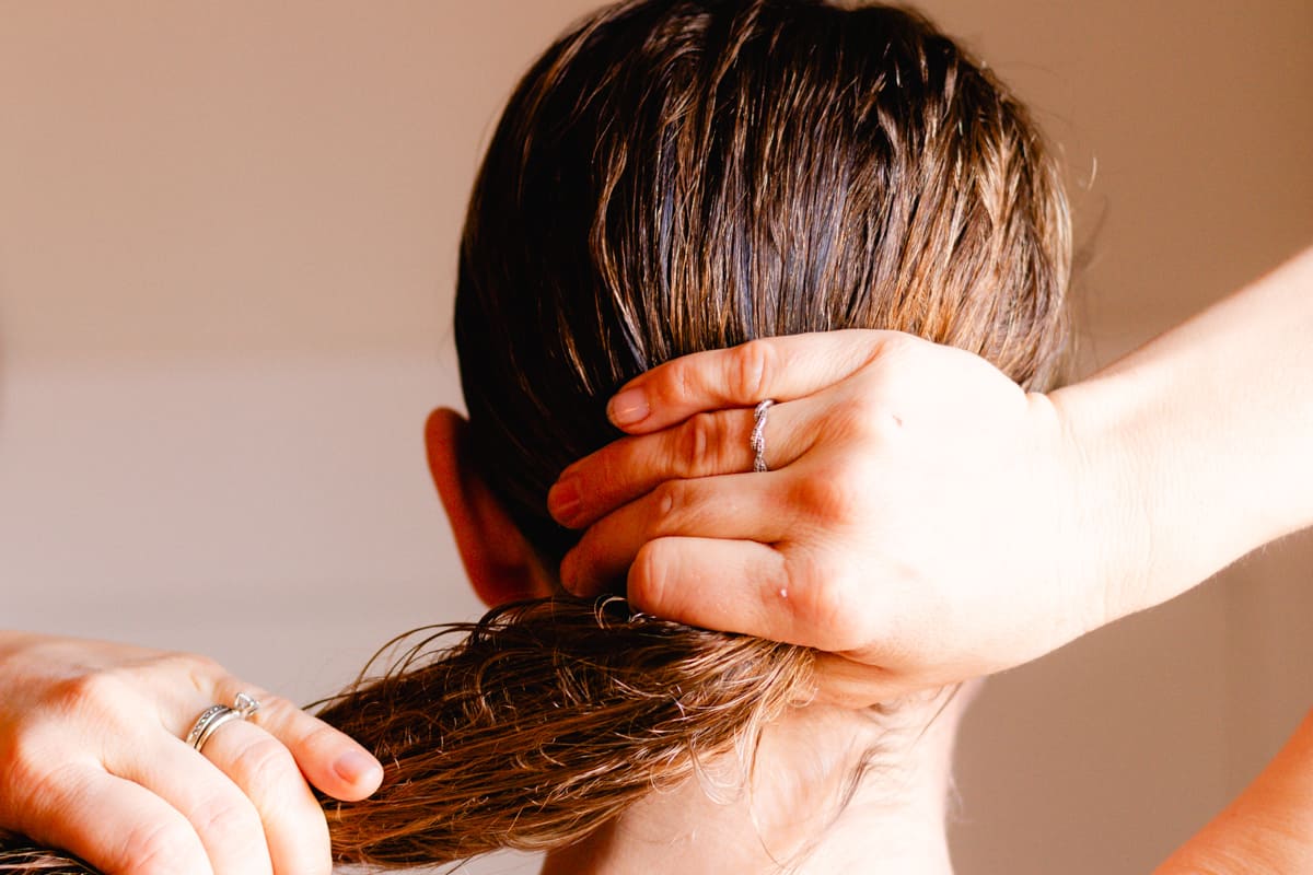 Working the castor oil hair mask into the strands of my hair.