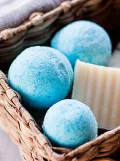 Homemade blue shower bombs being stored in a wicker basket.