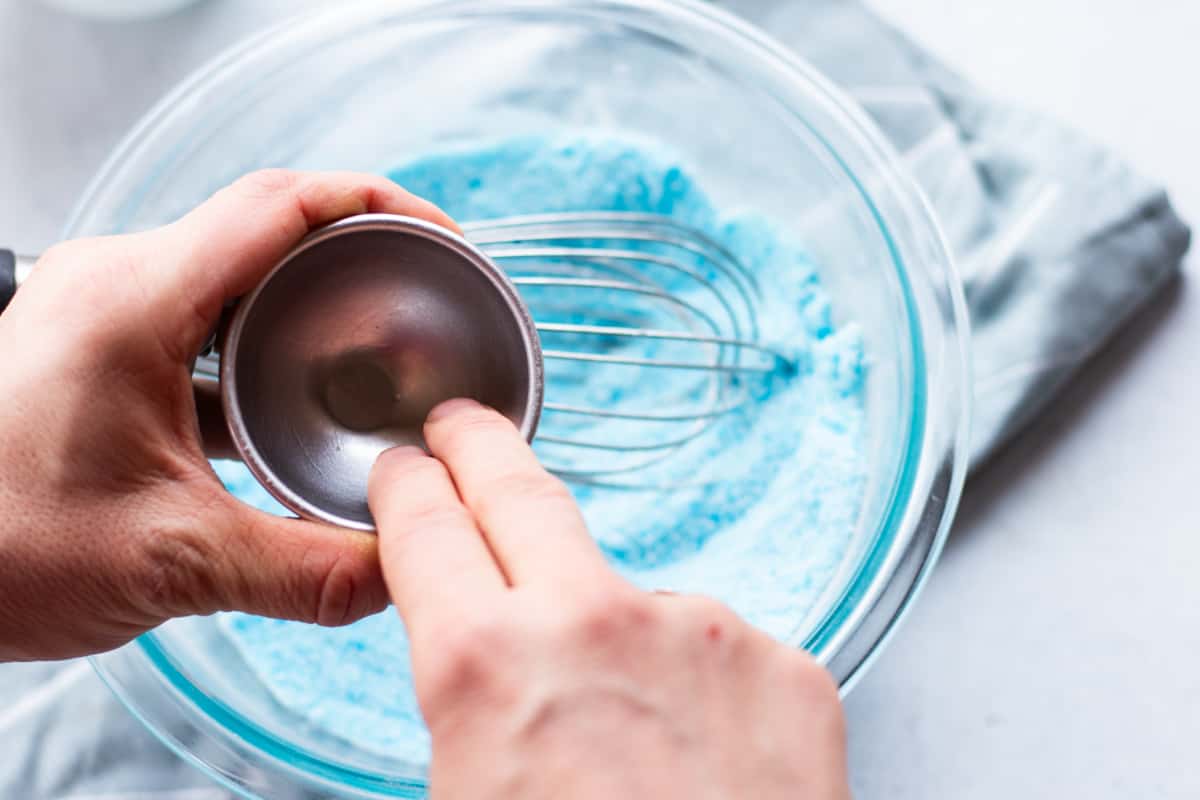 Oiling the shower bomb mold to make it easier to remove once it hardens.