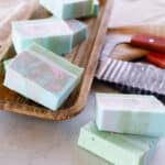 Melt and pour coconut oil soap bars with marbled colorings on a drying rack.