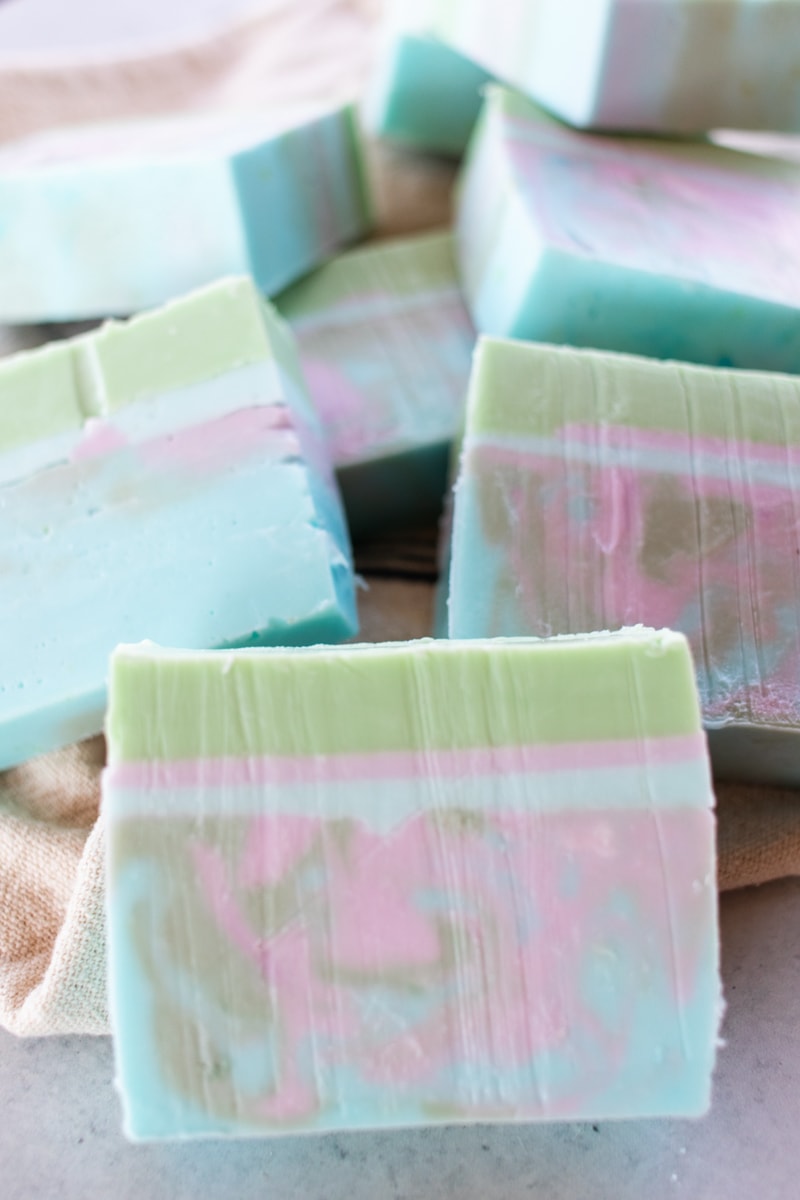 A pile of colorful bars of DIY melt-and-pour coconut oil soap.