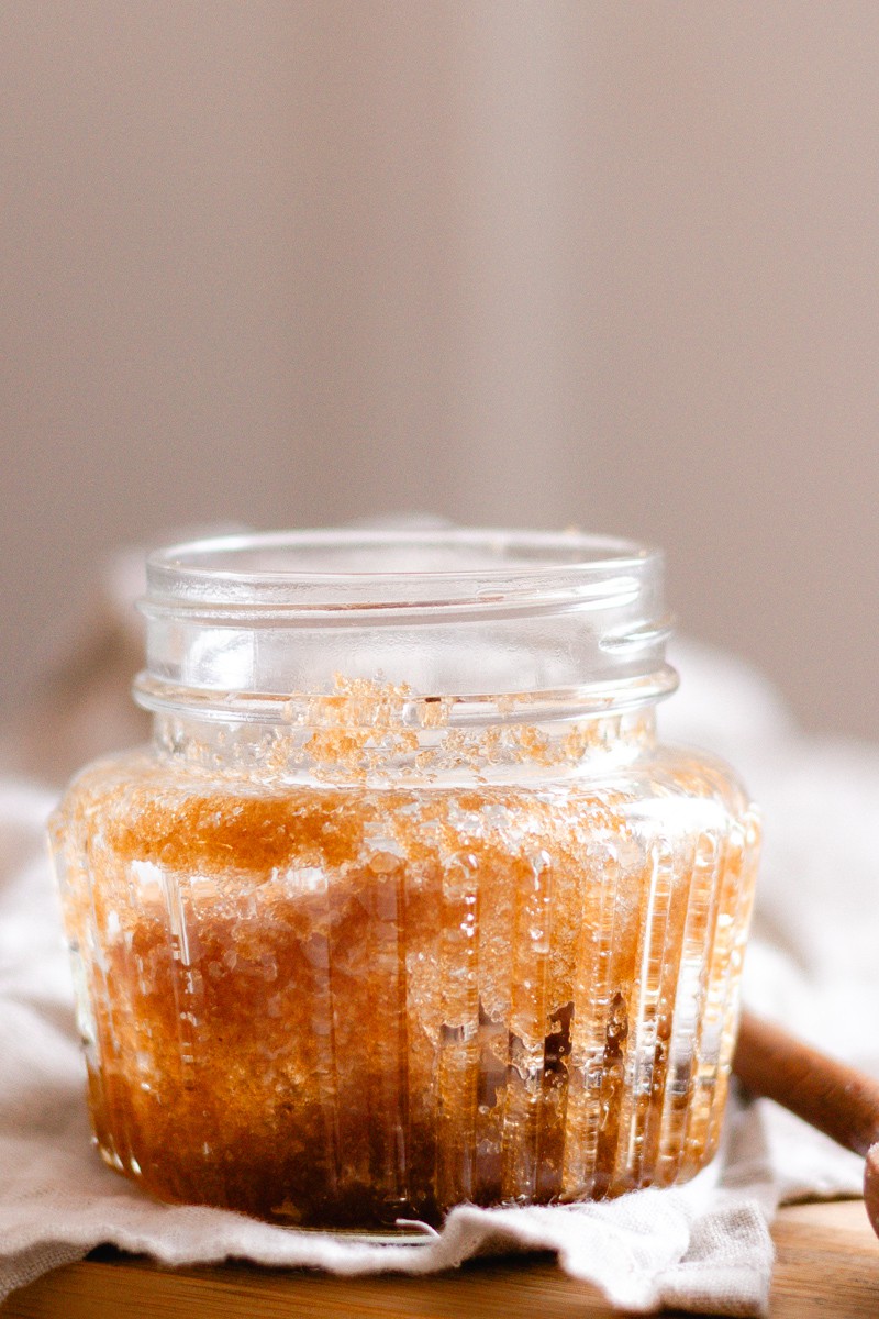 Close up picture of the scalp scrub while its sitting on an almond colored towel.