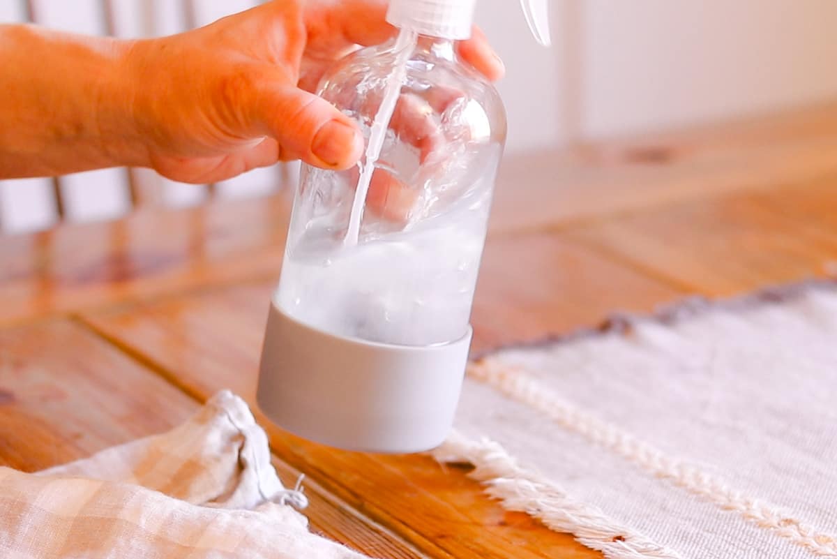 Shaking the homemade fly spray ingredients well before using.