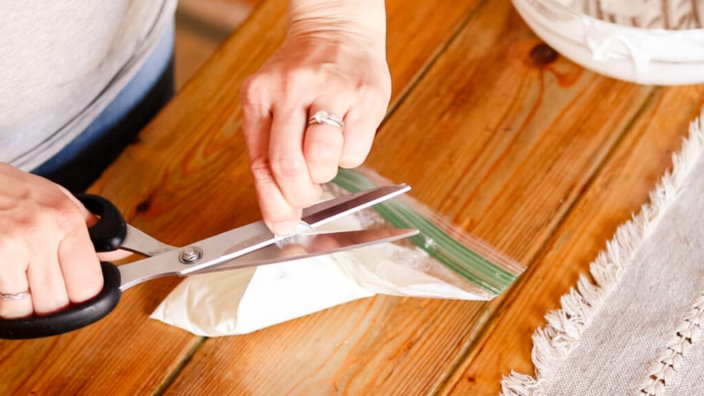 Snipping off the corner of a zippered bag to make a pipette.